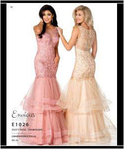 Two women wearing floor-length, sleeveless mermaid gowns in pink and champagne with lace and tulle details.